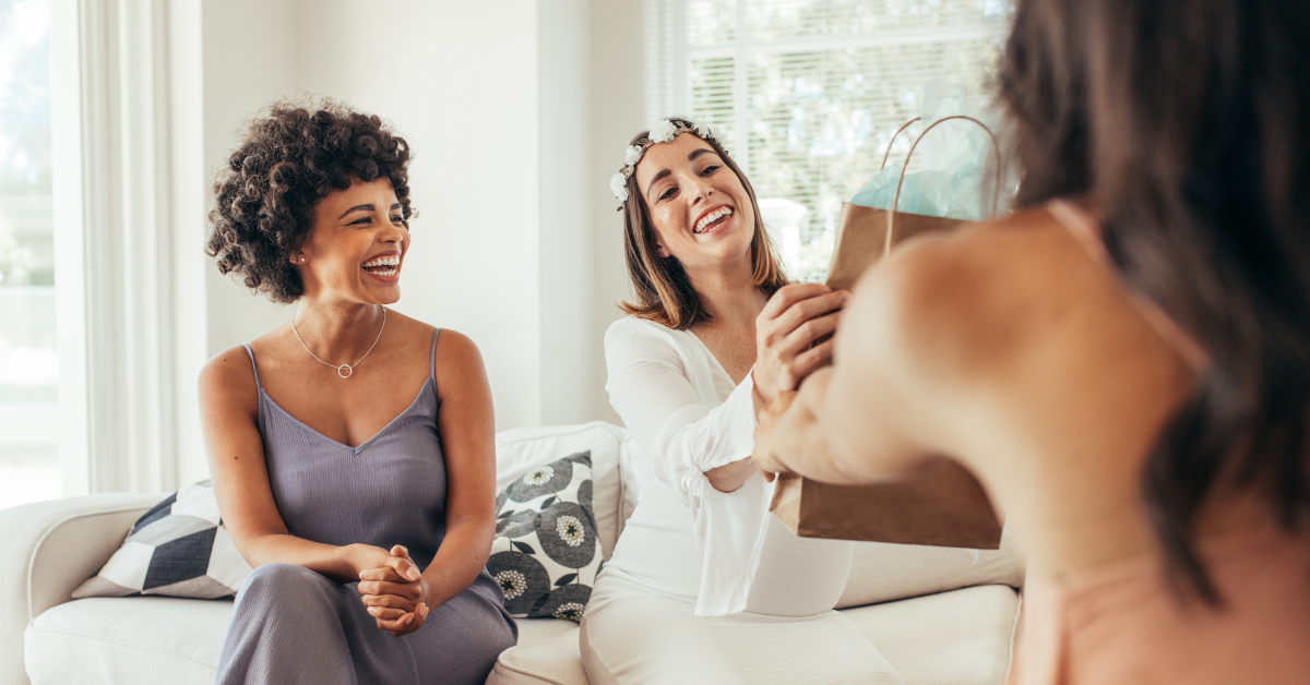 Pregnant women receiving postpartum gifts from friends.