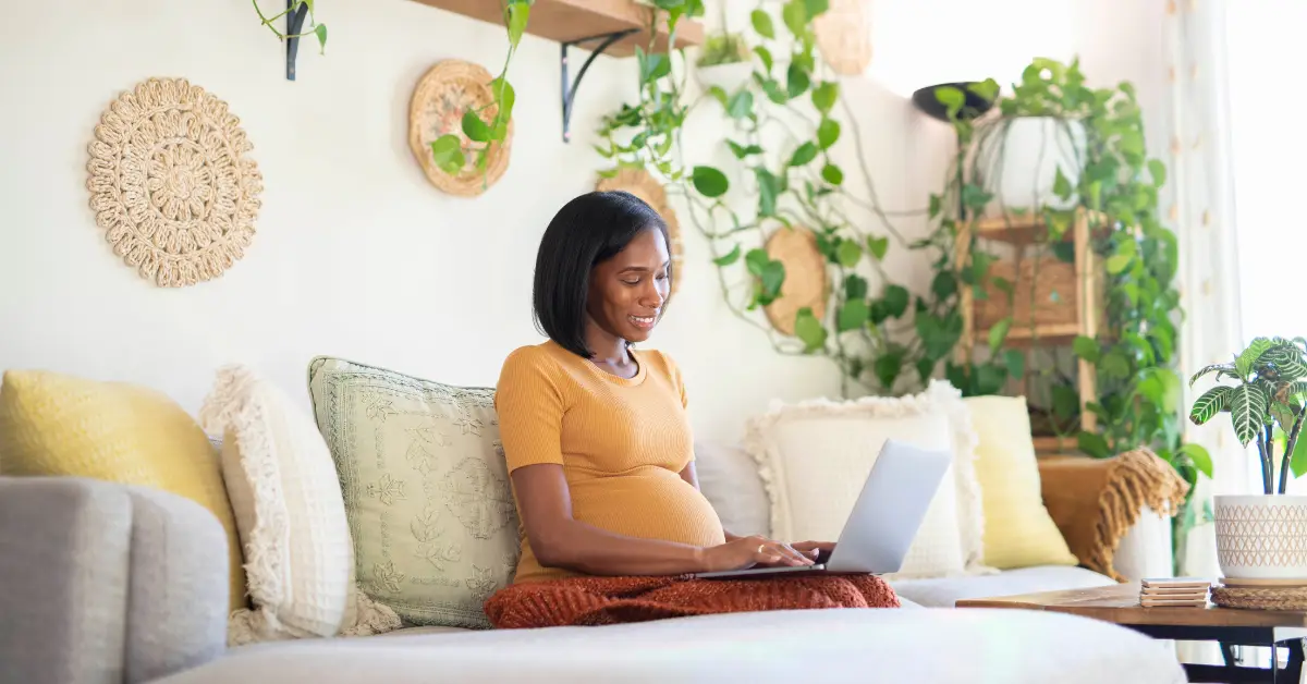 Pregnant woman researching for must haves before birth